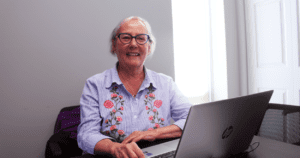 A woman sitting at a laptop computer.