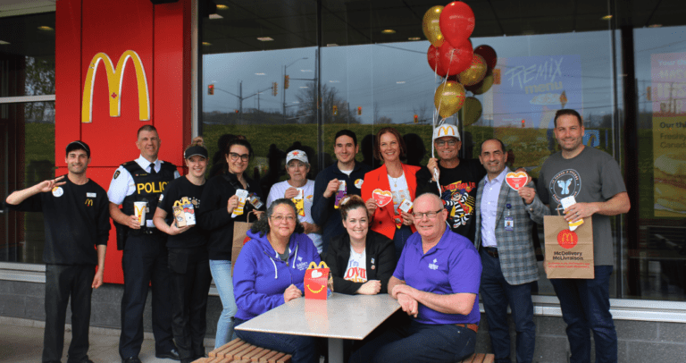 A group of people posing for a picture at a mcdonalds.