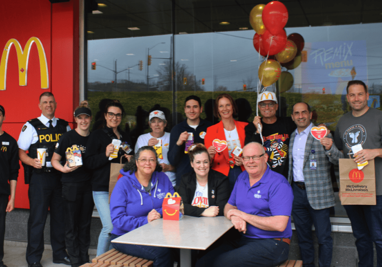 A group of people posing for a picture at a mcdonalds.